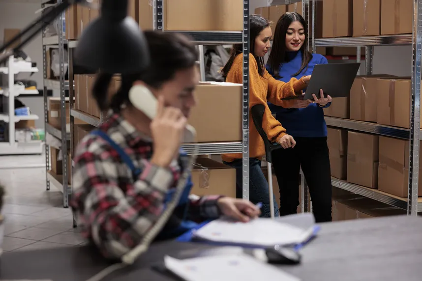 Warehouse employees using an inventory management system.