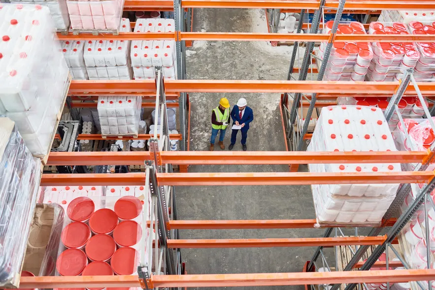 High-angle view of warehouse workers inspecting inventory.